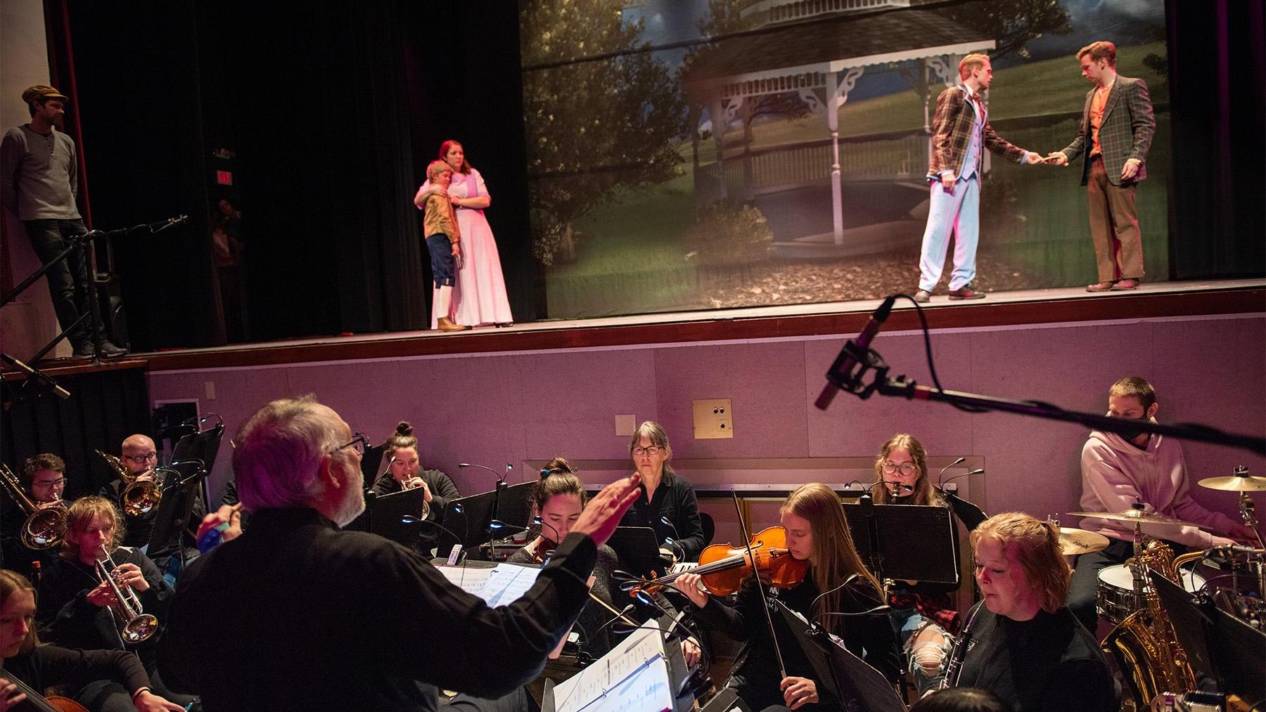 Students in the Music Man with a full orchestra.